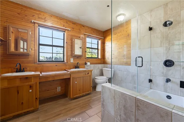 a large bathroom with a tub a sink and a large mirror