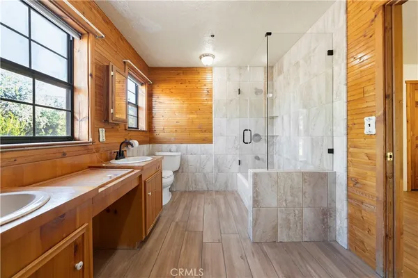 a view of a bathroom with a tub sink shower and a mirror