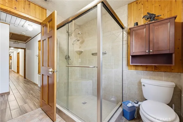 a bathroom with a toilet and a shower
