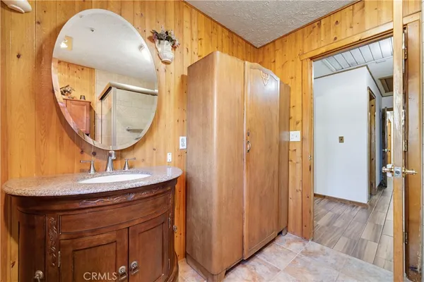 a bathroom with a sink a mirror a vanity and a shower