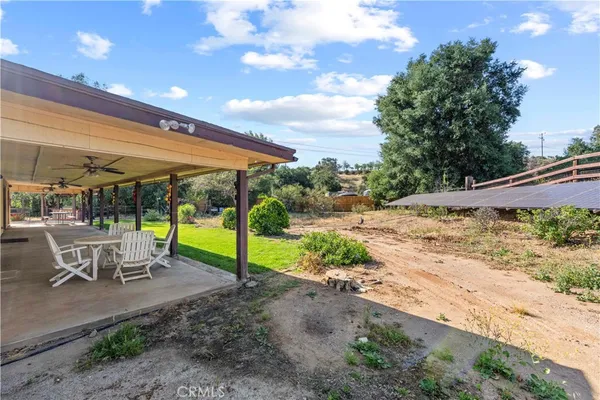 a view of a patio with a table and chairs under an umbrella