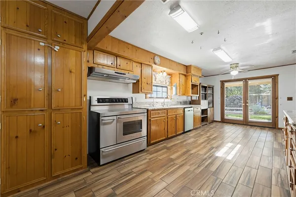 a kitchen with stainless steel appliances a stove a sink and a refrigerator