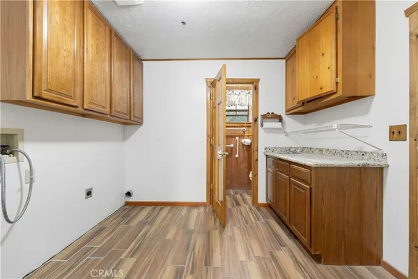 a kitchen with wooden floor and cabinets