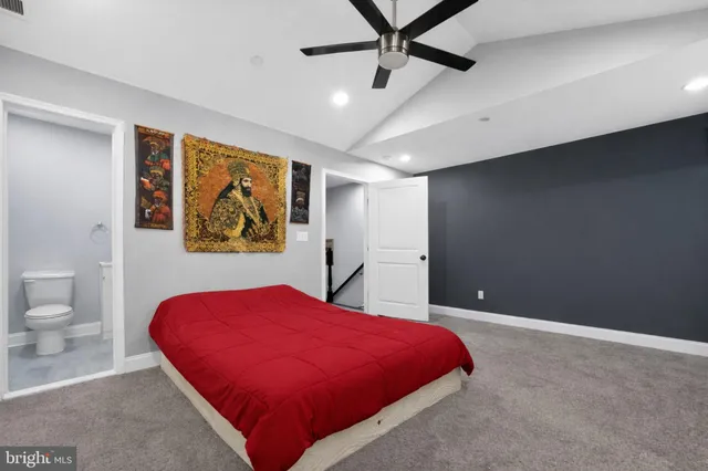 a bed room with a bed and a painting on the wall