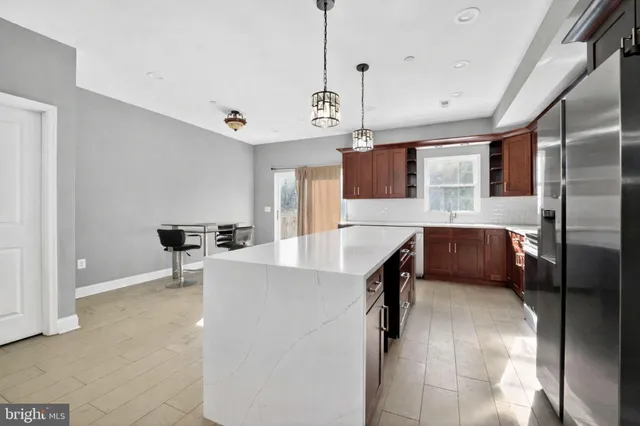 a view of kitchen with windows and refrigerator
