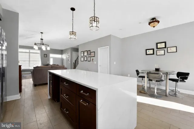 a kitchen with a dining table chairs and white cabinets