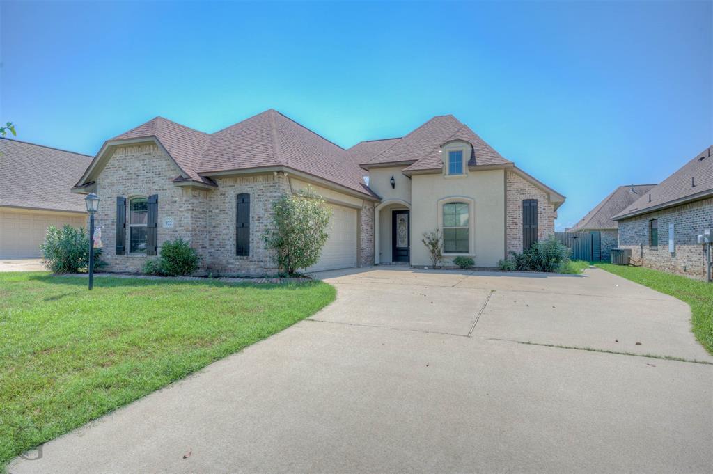 922 Antler Drive Haughton, LA 71037 - Photo 2 of 24 Brick and stucco exterior with a dormer window, concrete driveway, and attached garage