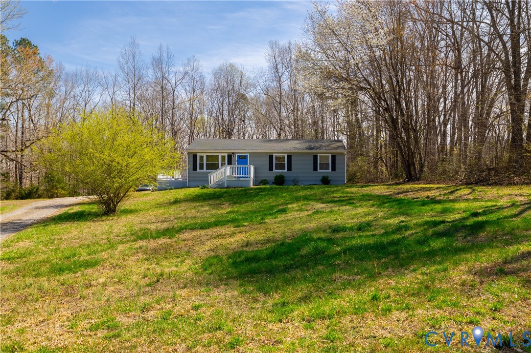 9813 Colemans Lake Road Ford, VA 23850 - Photo 32 of 38 a view of a house with a big yard and large trees