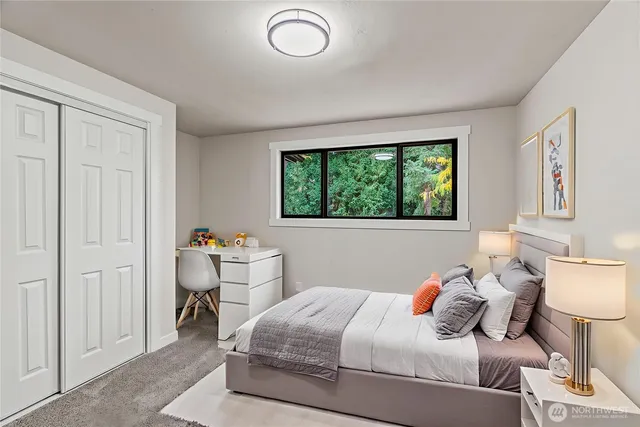 a bedroom with a bed and a window