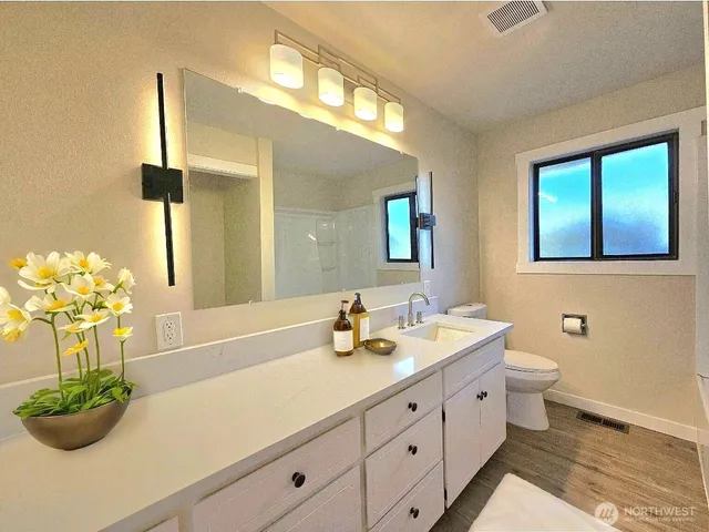 a bathroom with a double vanity sink mirror and
