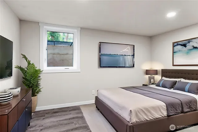 a bedroom with a bed and a potted plant