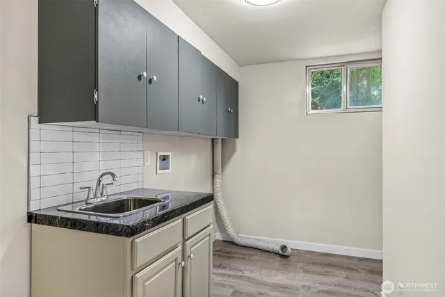 a kitchen with a sink and cabinets