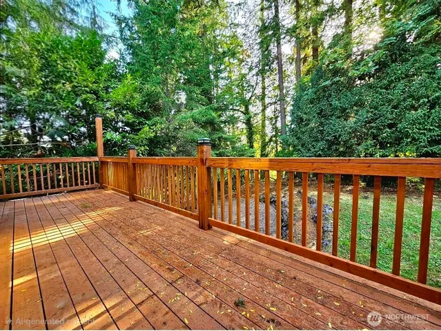 a view of wooden deck and a backyard
