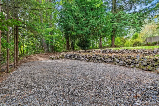a view of a road with trees in the background