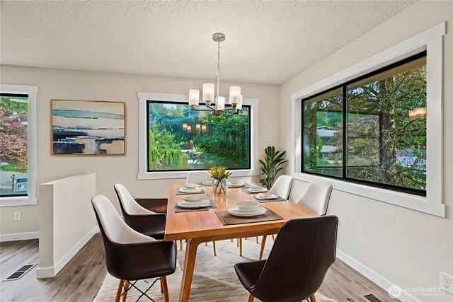 a dining room with furniture a chandelier and window