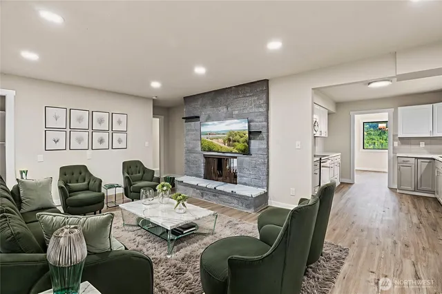 a living room with furniture and a wooden floor