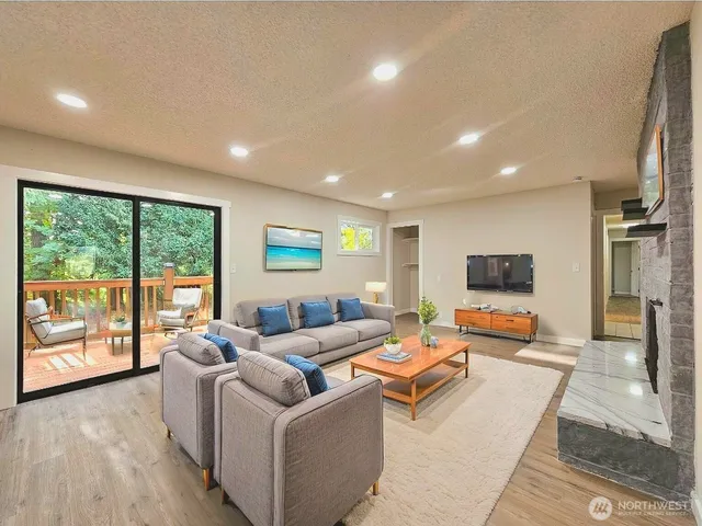 a living room with furniture and large windows