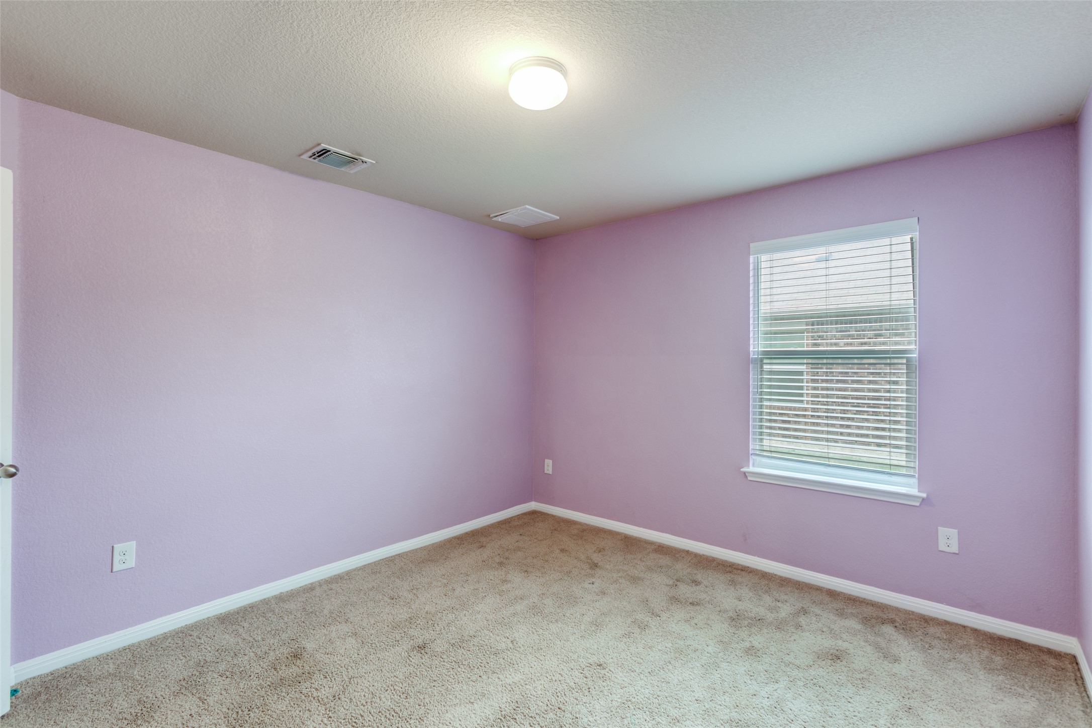 2909 Centrum Drive Austin, TX 78754 - Photo 24 of 30 This room features light purple walls, carpeted flooring, and a window with blinds