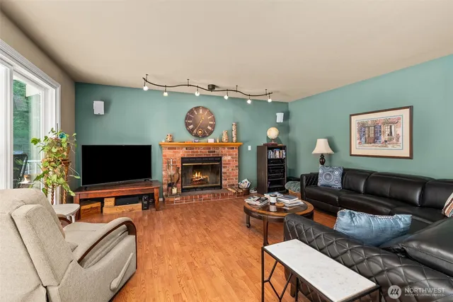 a living room with furniture a flat screen tv and a fireplace