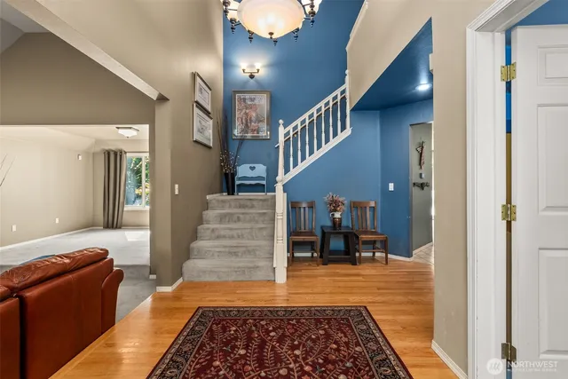 a room with stairs and a rug