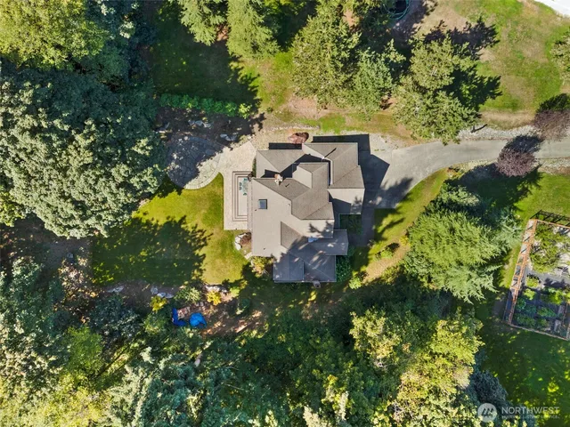 an aerial view of a house with a yard and garden