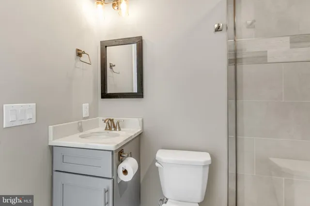 a bathroom with a toilet sink and mirror