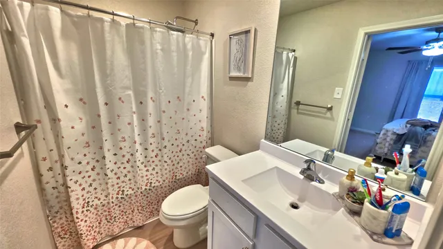 a bathroom with a sink toilet and shower
