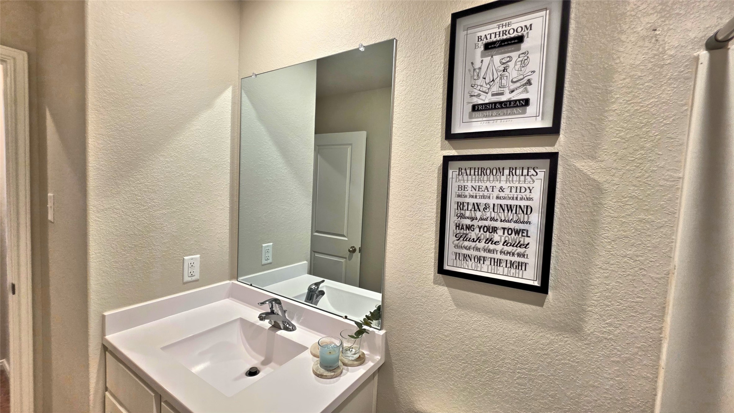 16351 Sweet Grv Drive Conroe, TX 77303 - Photo 14 of 19 a bathroom with a sink and a mirror