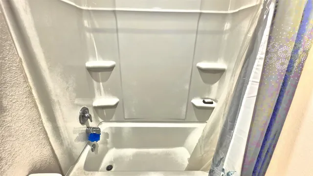 a bath tub sitting in a bathroom next to a sink