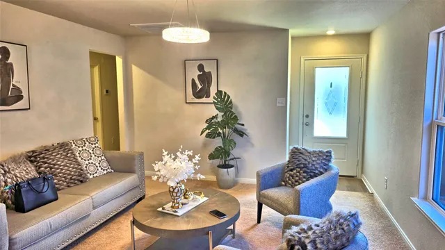 a living room with furniture and a potted plant