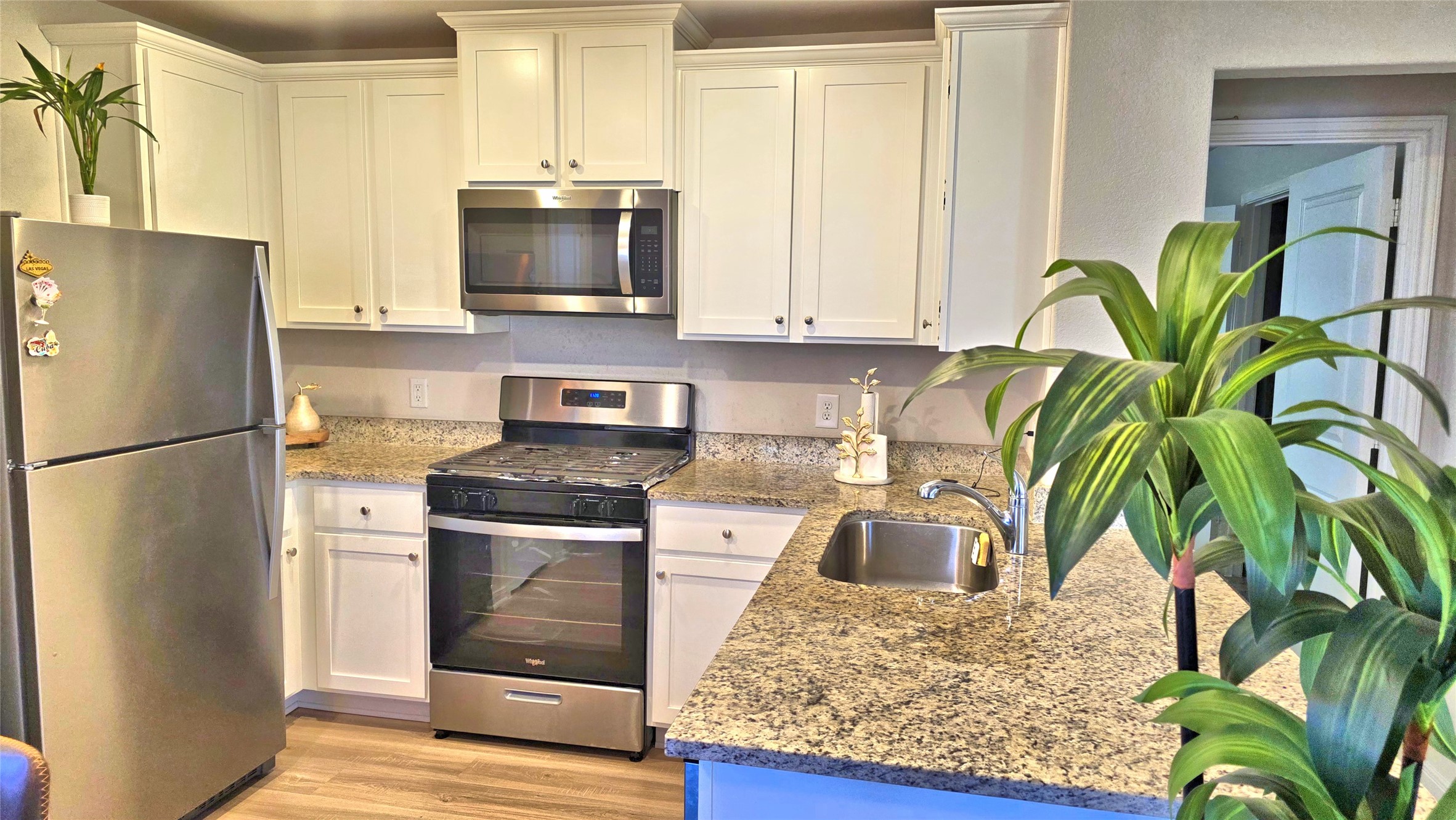 16351 Sweet Grv Drive Conroe, TX 77303 - Photo 7 of 19 a kitchen with stainless steel appliances granite countertop a refrigerator a stove a microwave and cabinets