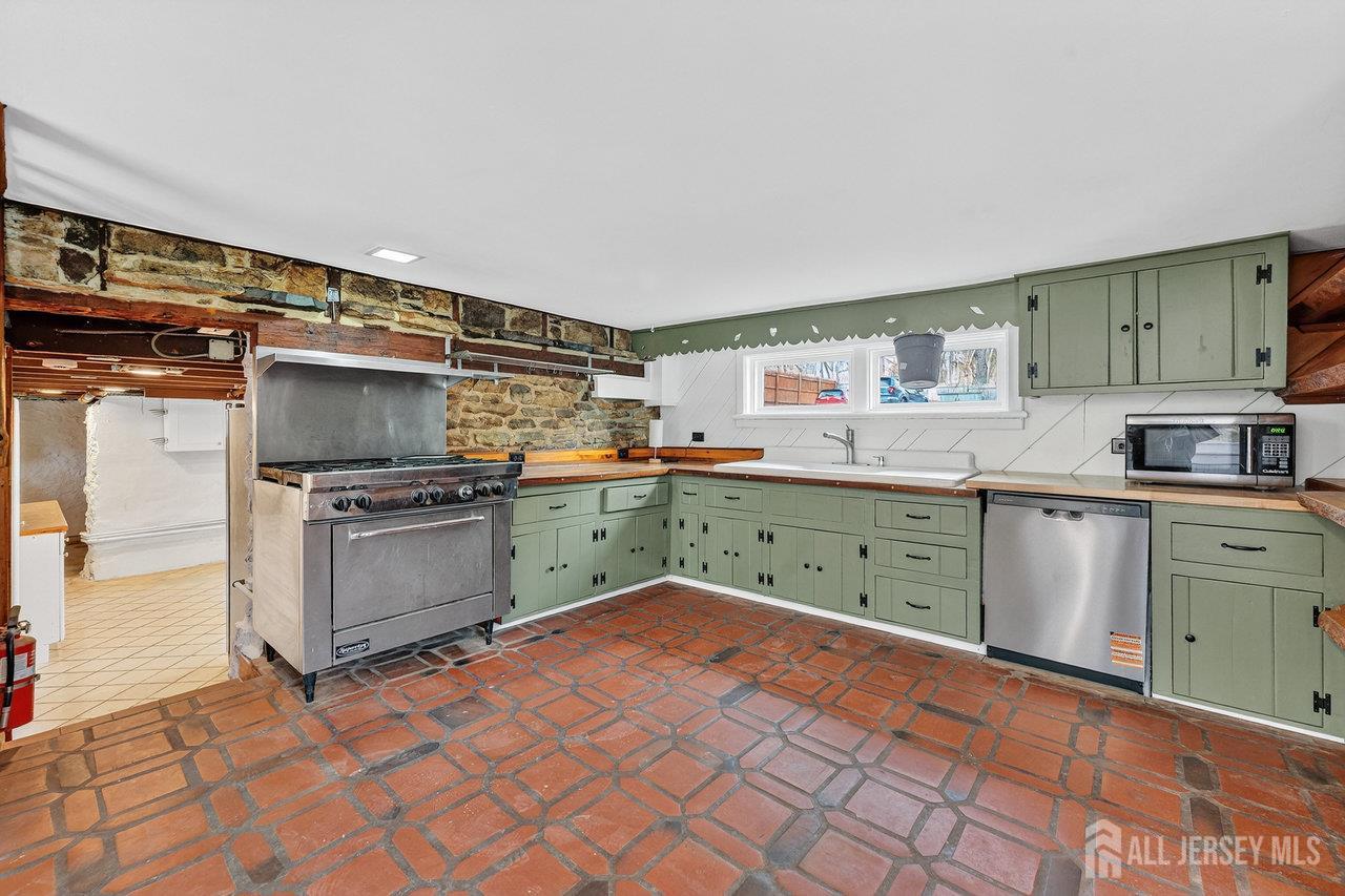 28 Old Clinton Road Flemington, NJ 08822 - Photo 11 of 39 a kitchen with stainless steel appliances a stove top oven a sink and a refrigerator