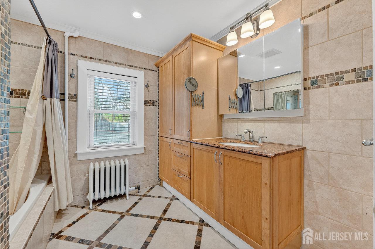 28 Old Clinton Road Flemington, NJ 08822 - Photo 14 of 39 a bathroom with a granite countertop sink a mirror and shower