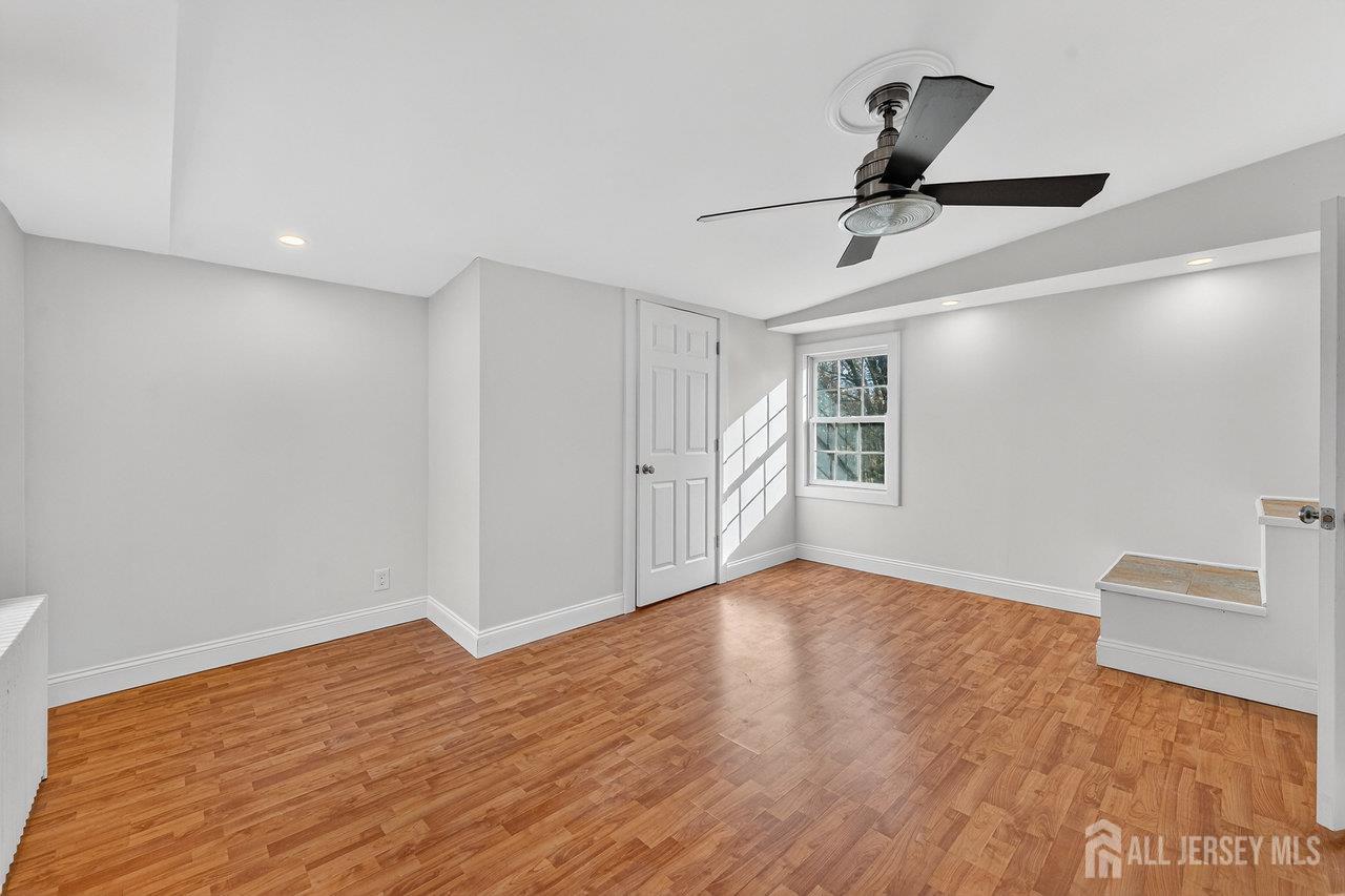 28 Old Clinton Road Flemington, NJ 08822 - Photo 15 of 39 a view of an empty room with window and wooden floor