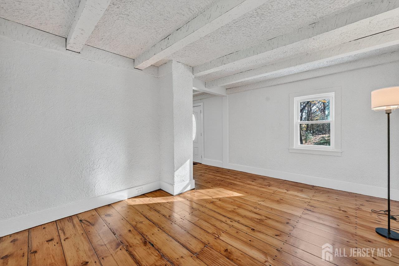 28 Old Clinton Road Flemington, NJ 08822 - Photo 5 of 39 a view of an empty room with wooden floor and a window