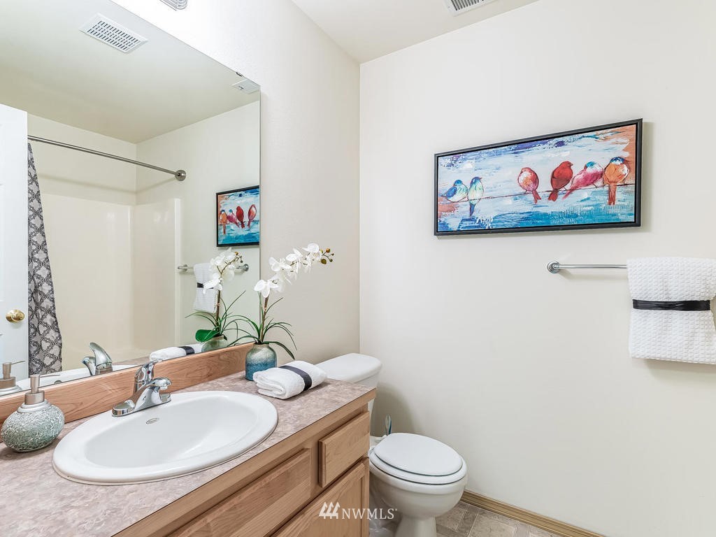 17022 105th Avenue Southeast Renton, WA 98055 - Photo 15 of 20 a bathroom with a granite countertop sink and a mirror