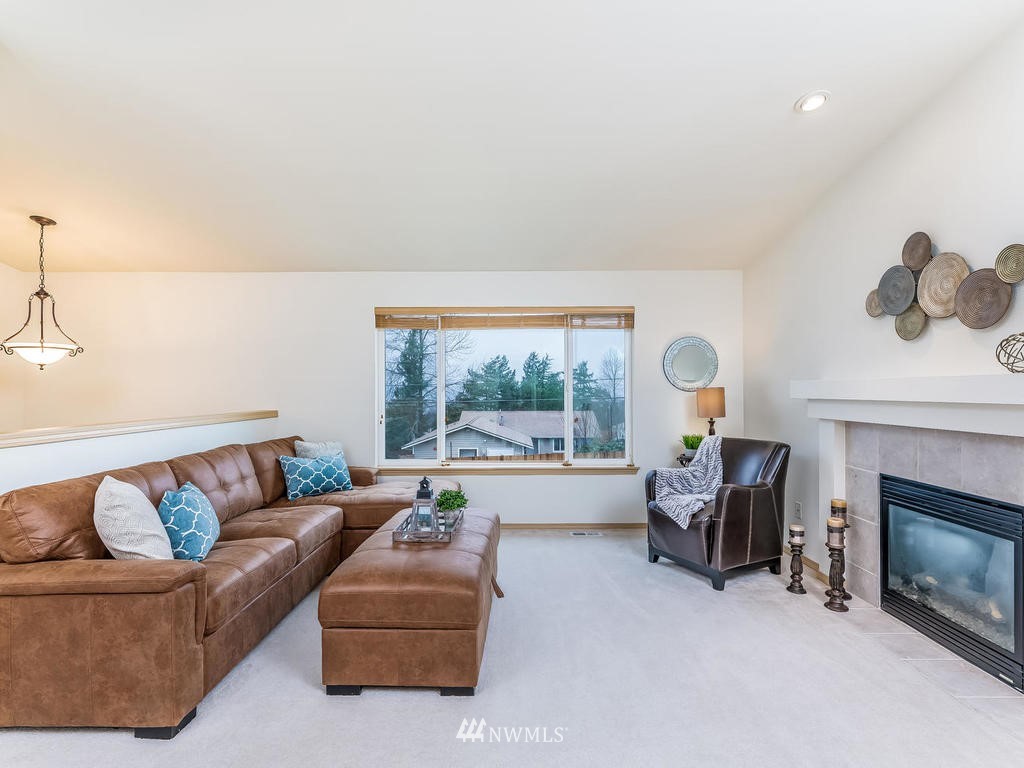 17022 105th Avenue Southeast Renton, WA 98055 - Photo 5 of 20 a living room with furniture and a fireplace