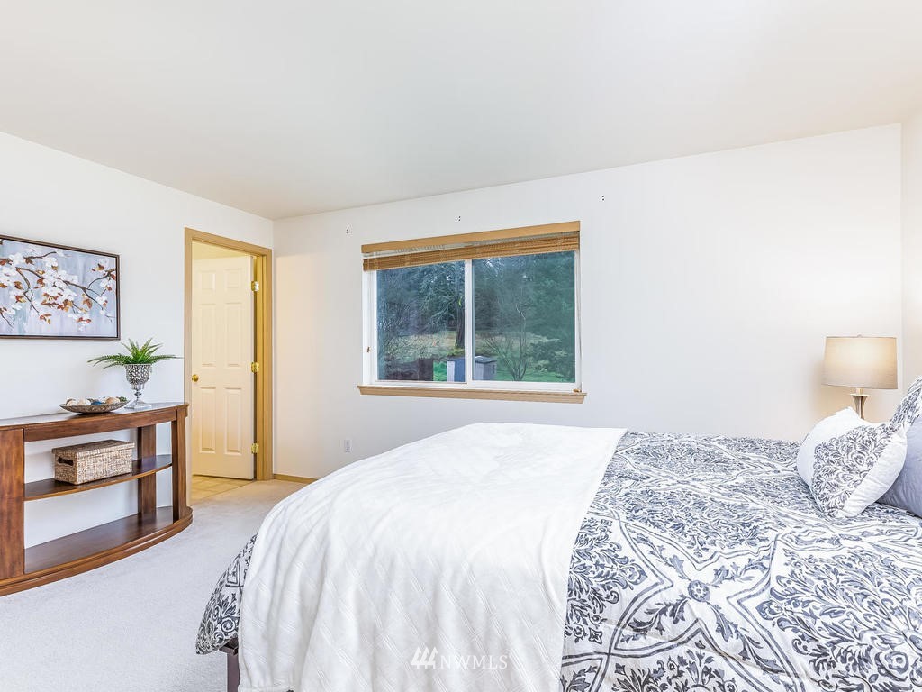 17022 105th Avenue Southeast Renton, WA 98055 - Photo 8 of 20 a bedroom with a large bed and a window