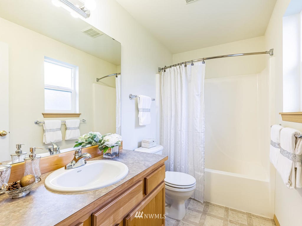 17022 105th Avenue Southeast Renton, WA 98055 - Photo 9 of 20 a bathroom with a sink toilet and shower