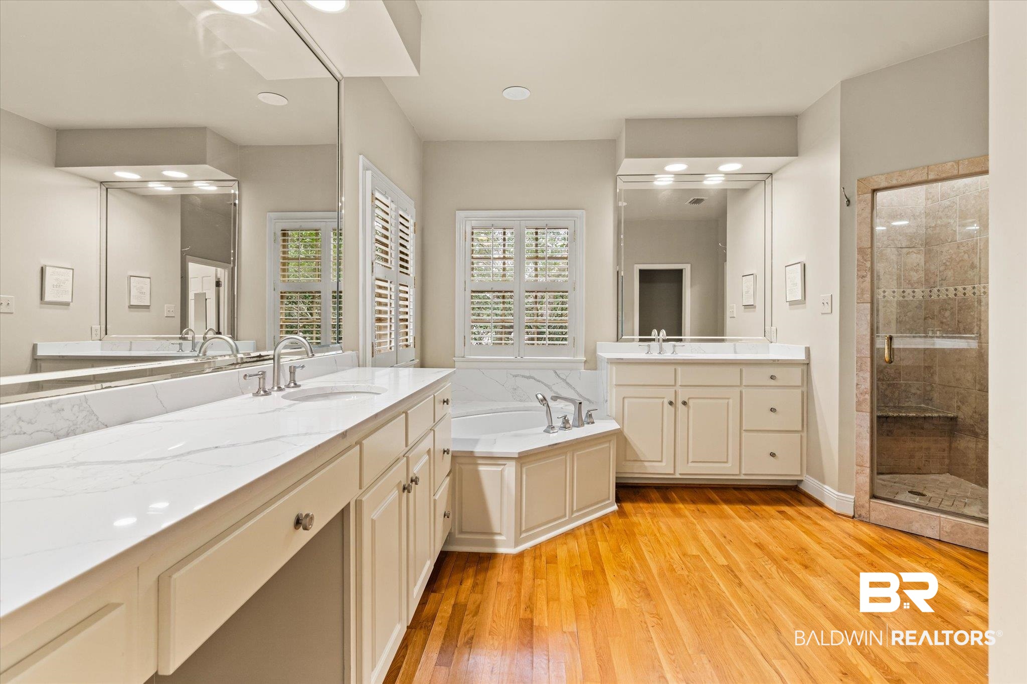 143 Myrtlewood Lane Mobile, AL 36608 - Photo 51 of 55 Bathroom with a garden tub, two vanities, a sink, wood finished floors, and a shower stall