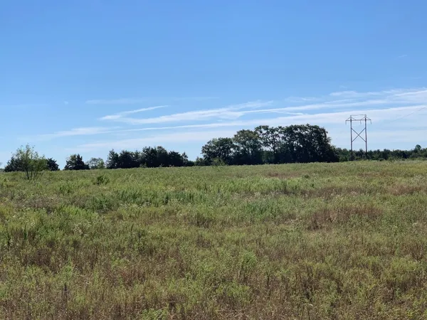 a view of a field with ocean view