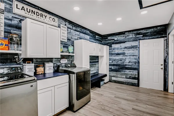 a kitchen with stainless steel appliances a refrigerator and a stove top oven