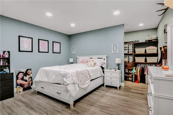 a bed room with a bed and a book shelf