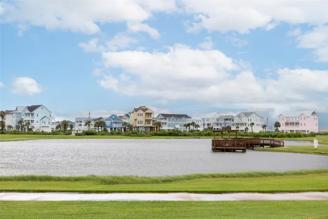 a view of swimming pool with a garden and trees in the background