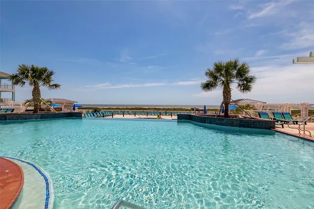 an aerial view of a building with garden space and ocean view