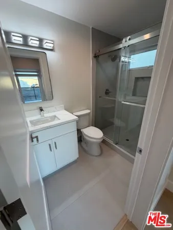 a kitchen with refrigerator and chairs