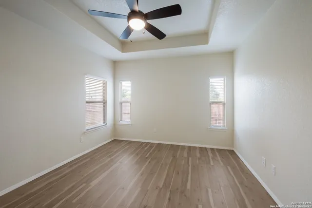wooden floor in an empty room with a window