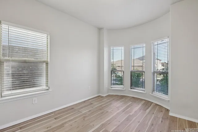 a view of a room with wooden floor and windows