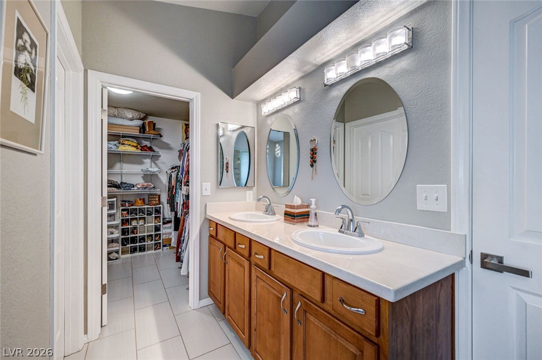 2600 Frontera Road Henderson, NV 89074 - Photo 34 of 47 Primary suite marble dual vanity and adjacent walk in closet