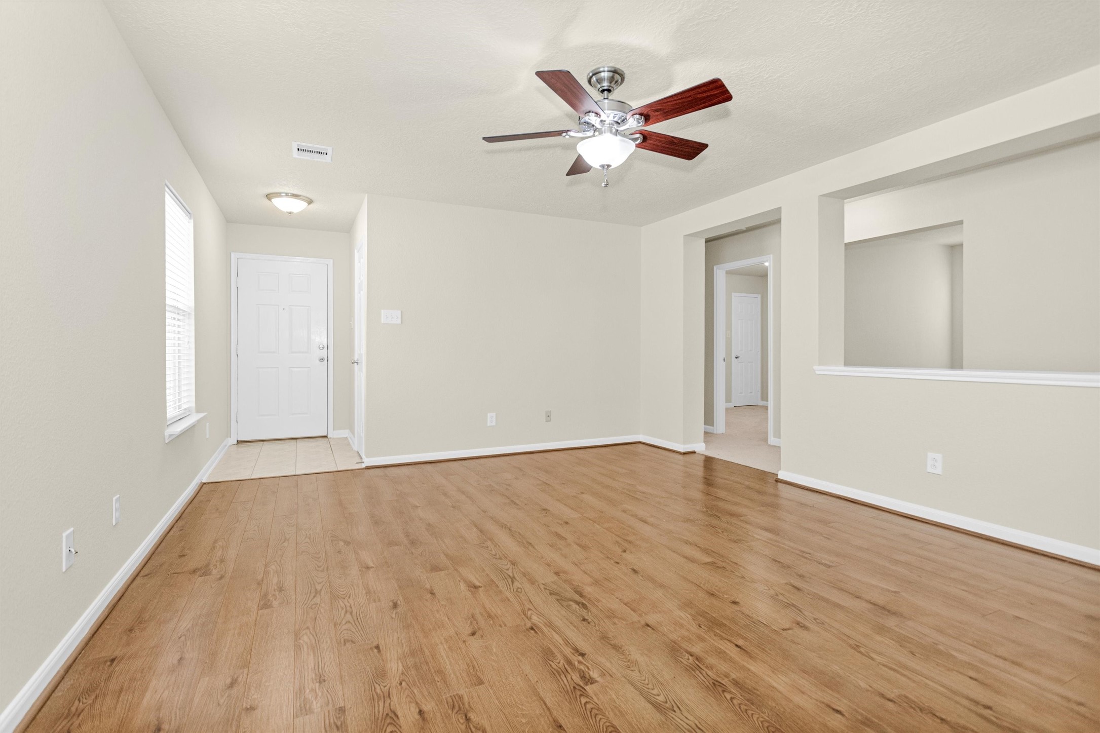 3131 Beacon Grove Street Spring, TX 77389 - Photo 8 of 38 a view of an empty room with wooden floor and a ceiling fan